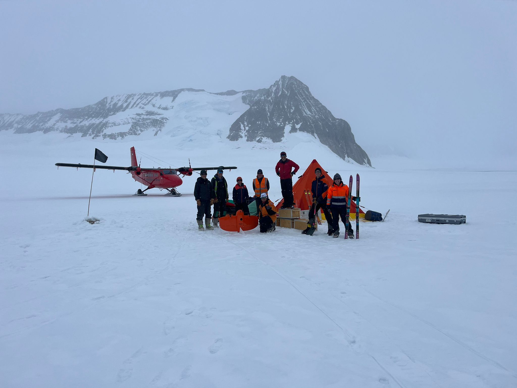 The team in front of their camp and a Twin Otter