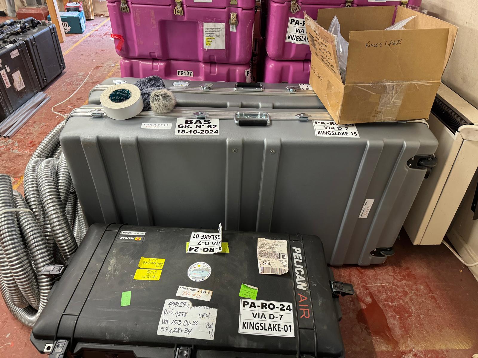 Wingtra UAV in boxes in the hangar at Rothera in fronnt of boxes of seismometers